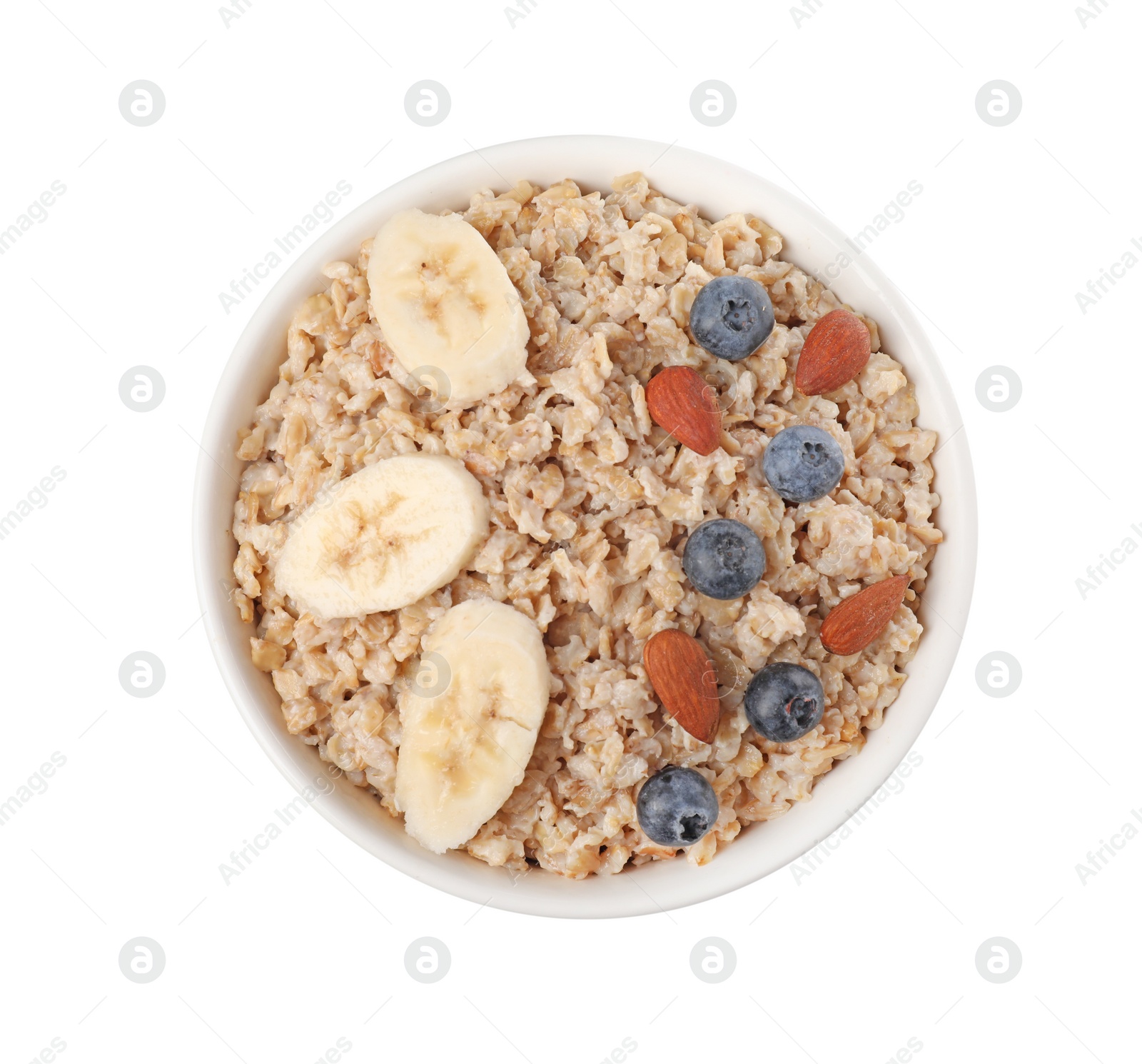 Photo of Tasty boiled oatmeal with blueberries, almonds and banana in bowl isolated on white, top view