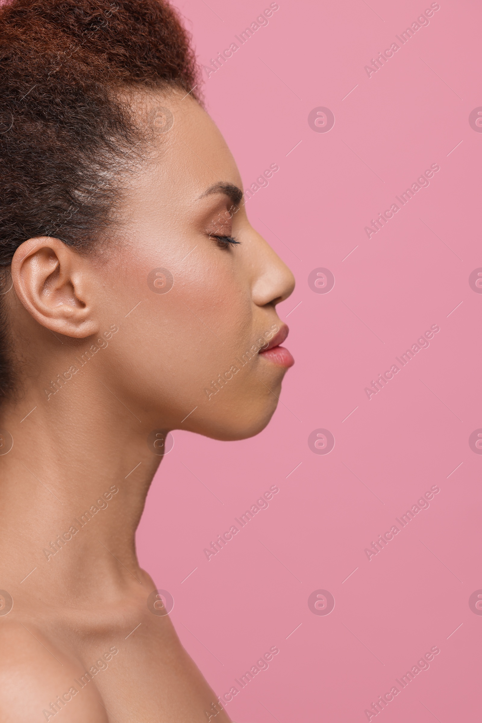 Photo of Beautiful young woman with glamorous makeup on pink background