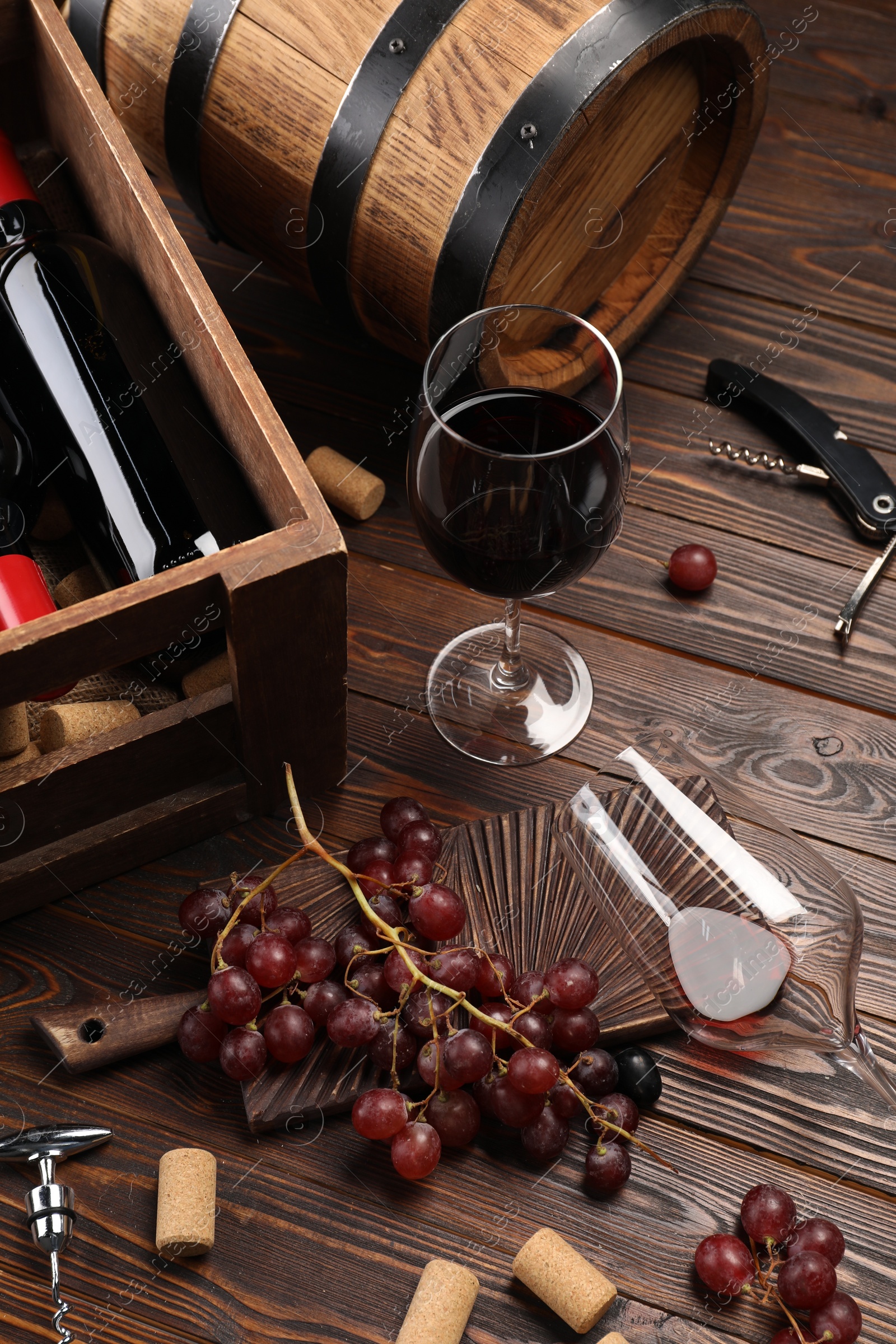 Photo of Winemaking. Composition with tasty wine and barrel on wooden table, above view