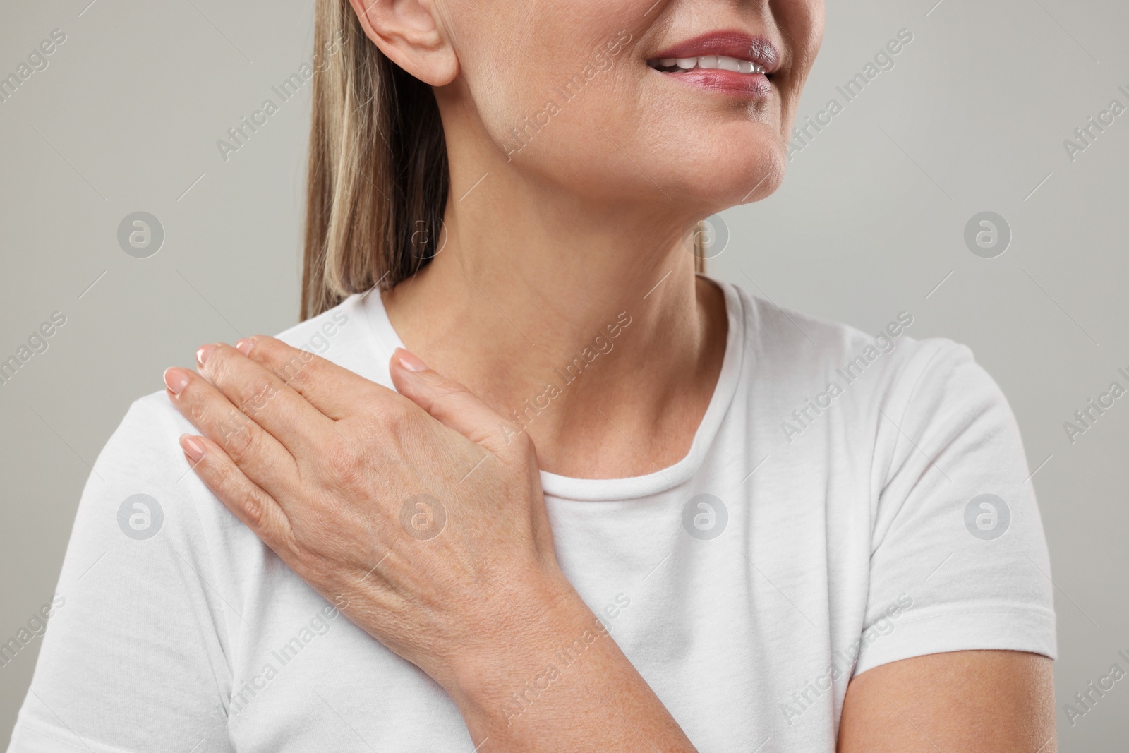 Photo of Mature woman with healthy skin on grey background, closeup