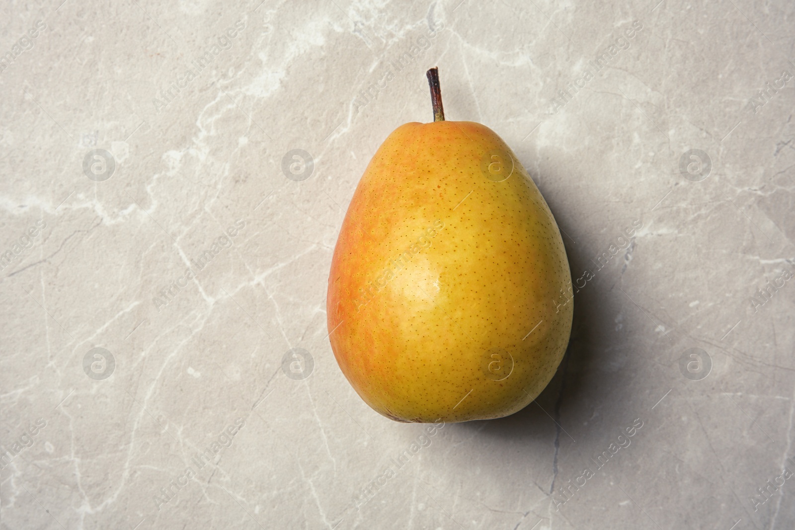 Photo of Ripe pear on grey background, top view