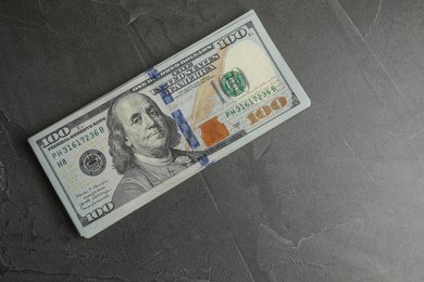 Money exchange. Dollar banknotes on dark gray textured background, top view