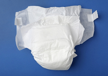 Photo of Baby diaper on blue background, top view