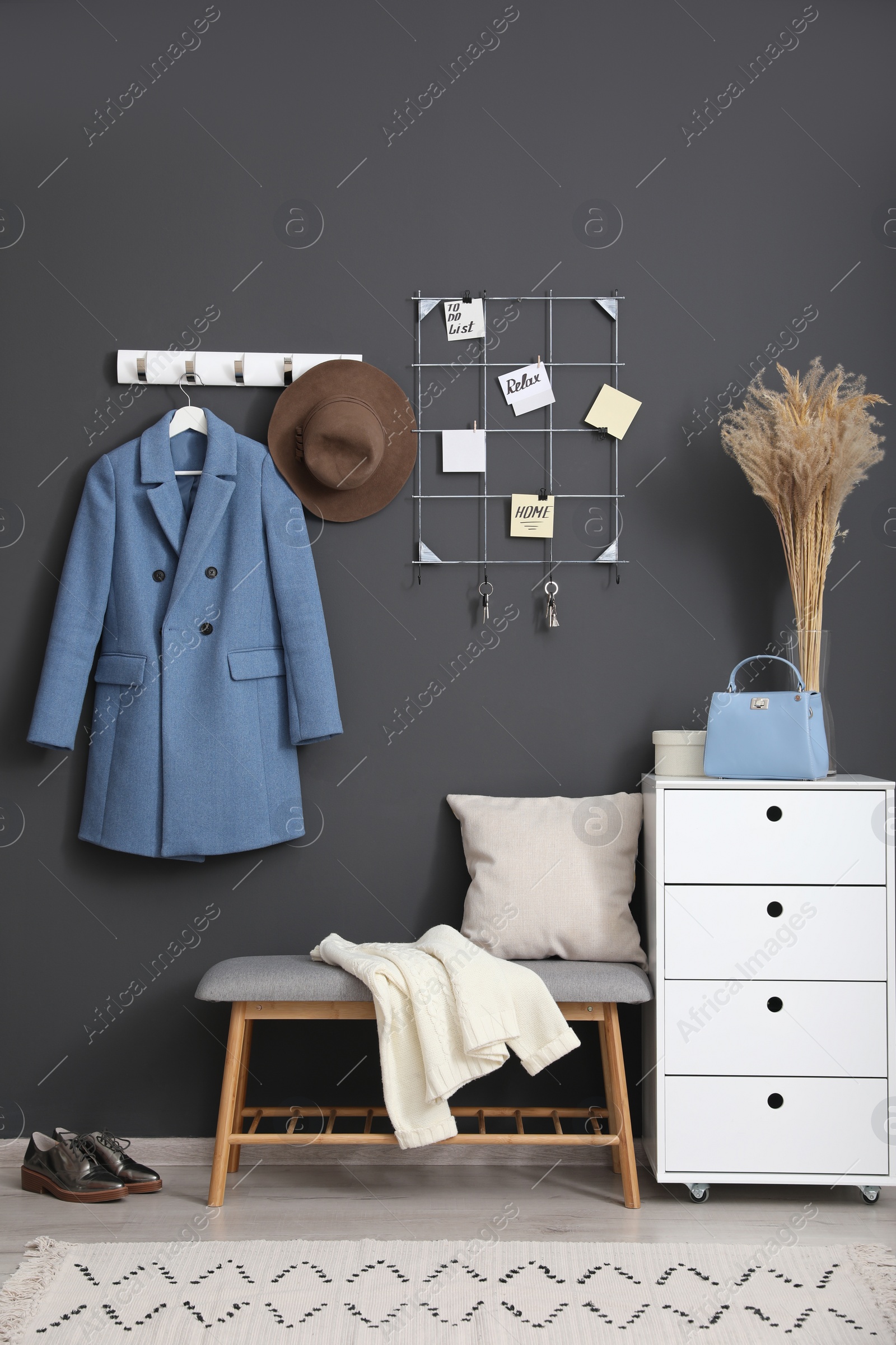 Photo of Hallway interior with stylish furniture, clothes and accessories
