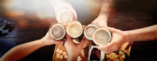 Image of Group of friends toasting with beer in pub, top view. Banner design