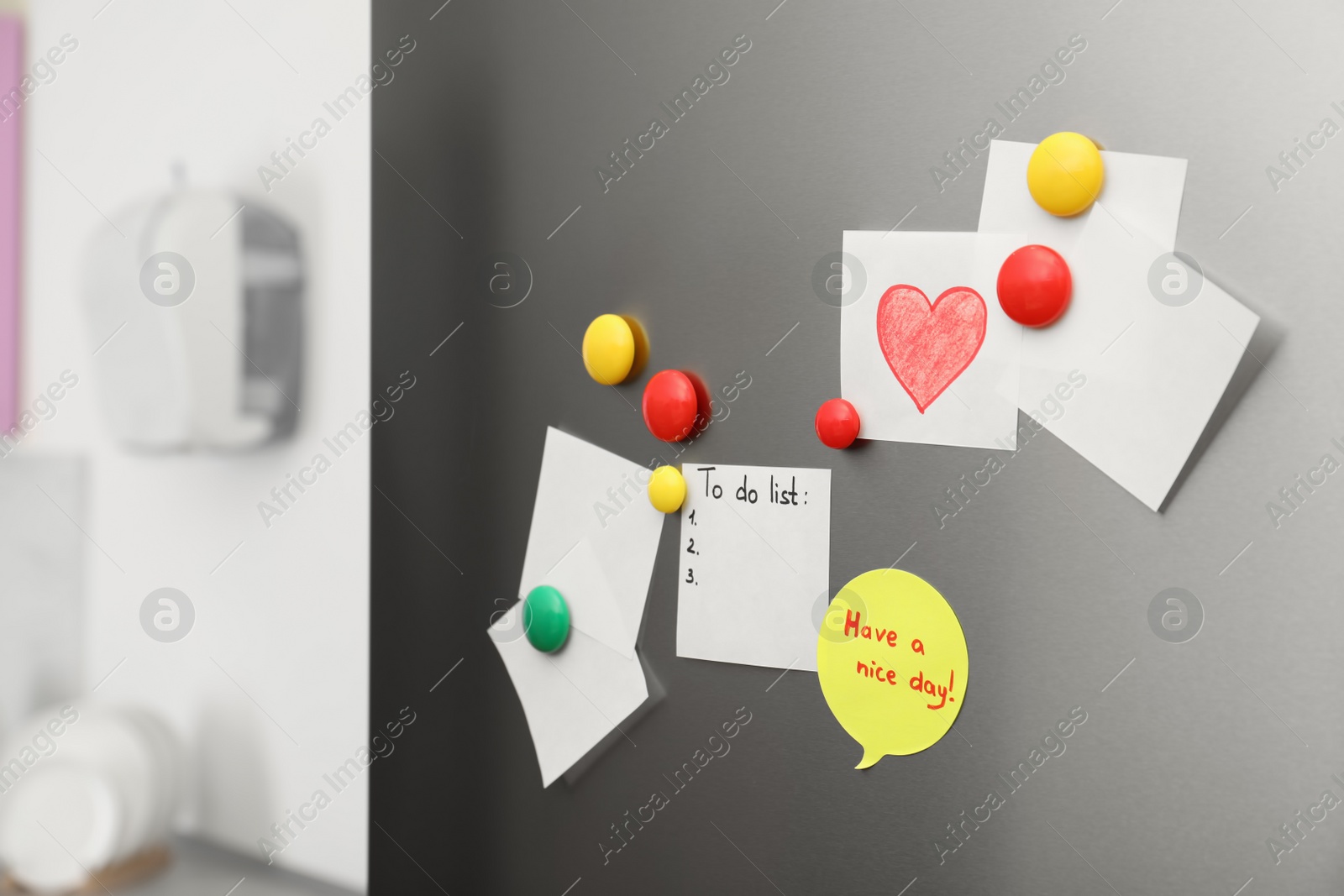 Photo of Paper sheets and magnets on refrigerator door indoors