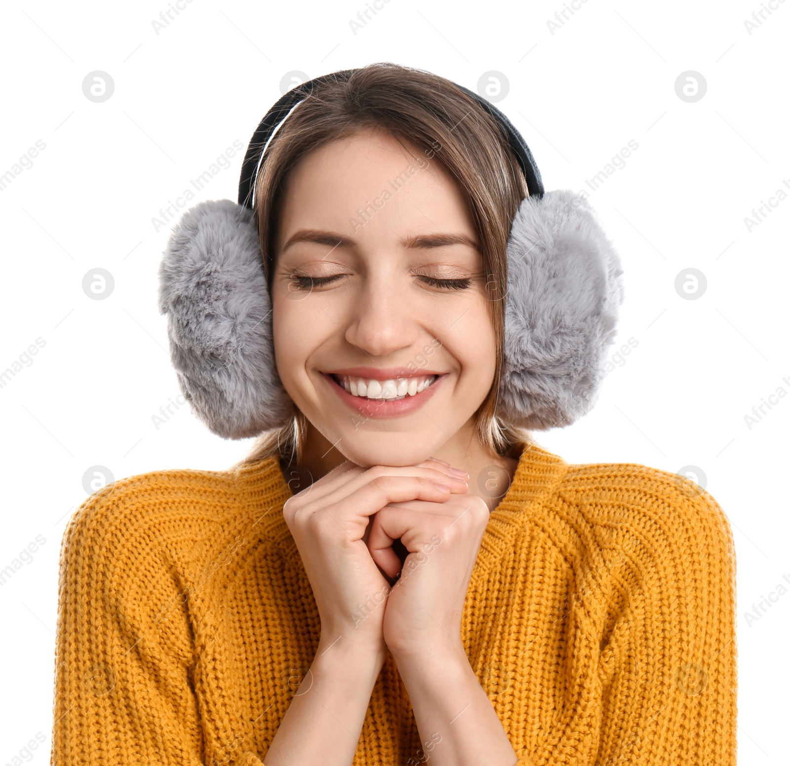 Photo of Happy woman wearing warm earmuffs on white background