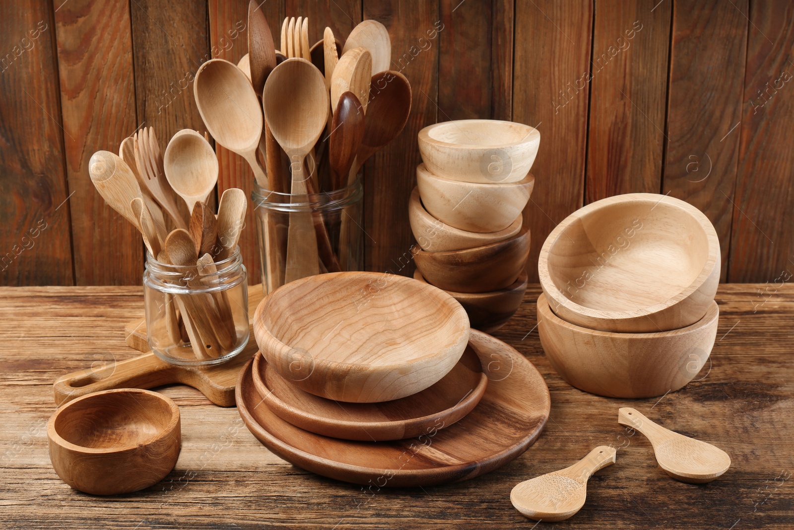 Photo of Many different wooden dishware and utensils on table