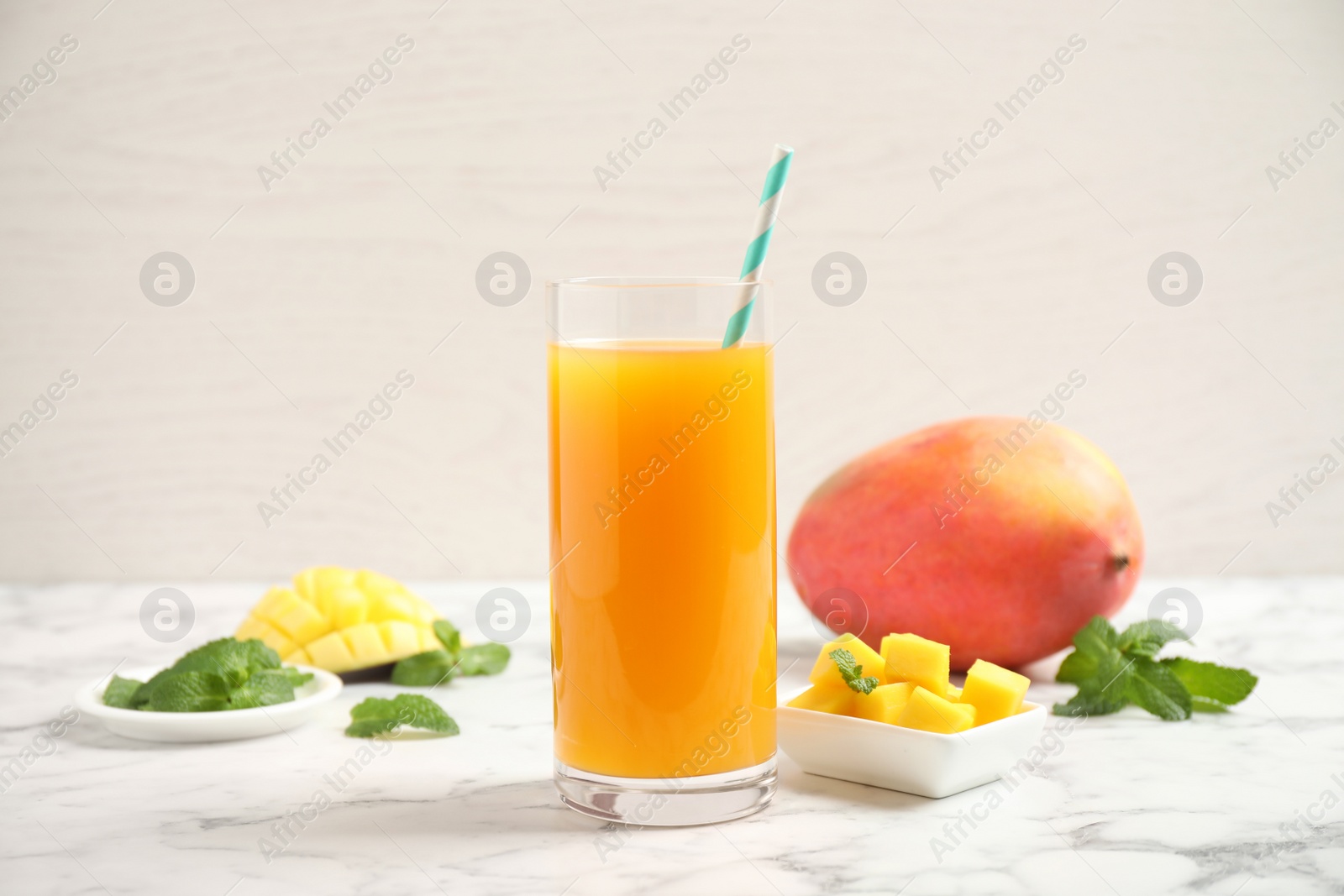 Photo of Fresh delicious mango drink on marble table