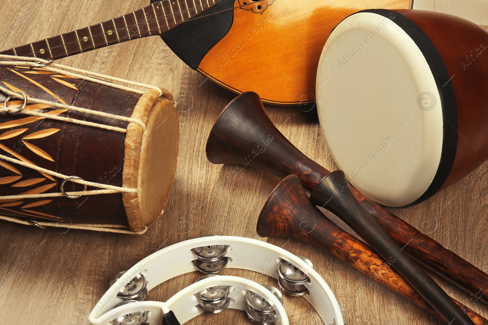 Photo of Set of different vintage musical instruments on wooden background, closeup