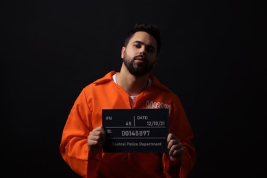 Prisoner with mugshot letter board on black background