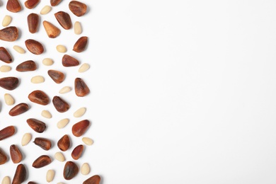 Photo of Composition with pine nuts and space for text on white background, top view
