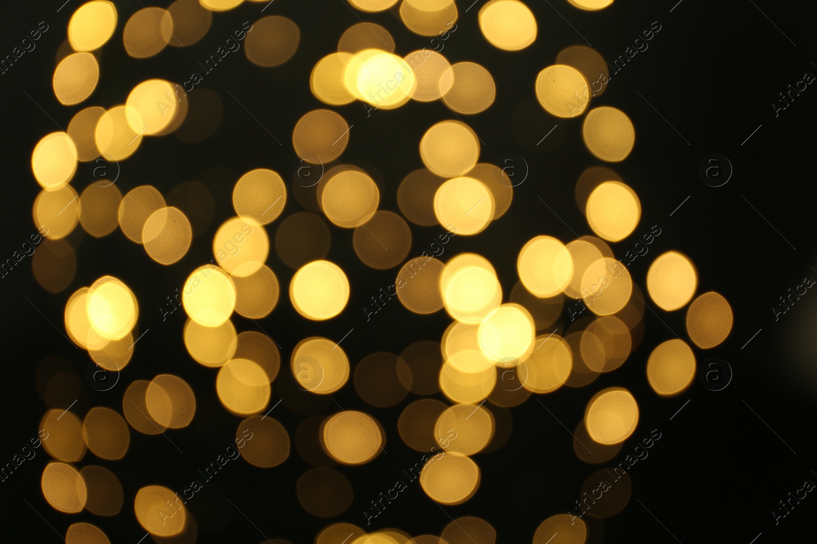 Photo of Blurred view of beautiful lights on black background. Bokeh effect