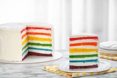 Photo of Delicious rainbow cake for party on table