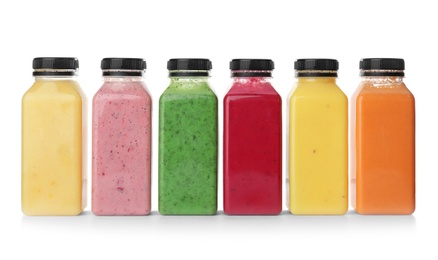 Photo of Bottles with delicious detox smoothies on white background