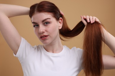 Photo of Portrait of beautiful woman with freckles on beige background