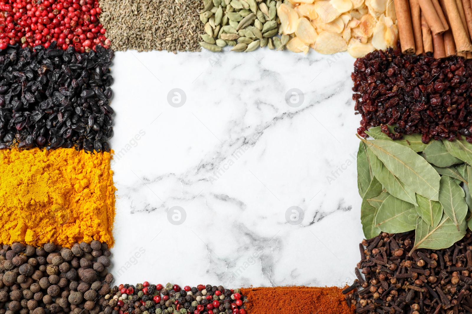 Photo of Frame made with different spices on white marble background, flat lay. Space for text