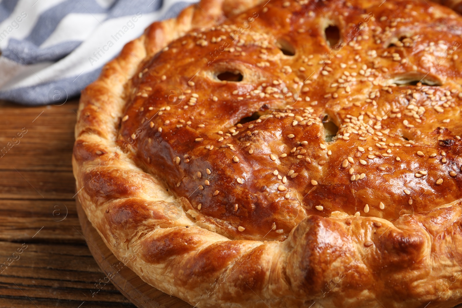 Photo of Tasty homemade pie and ingredients on wooden table, closeup