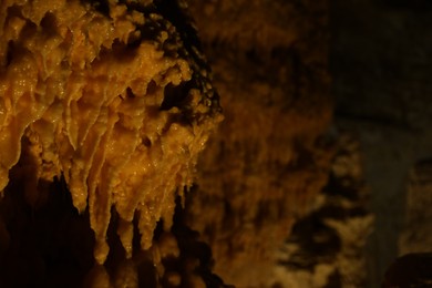 Many stalactite formations in cave, closeup view