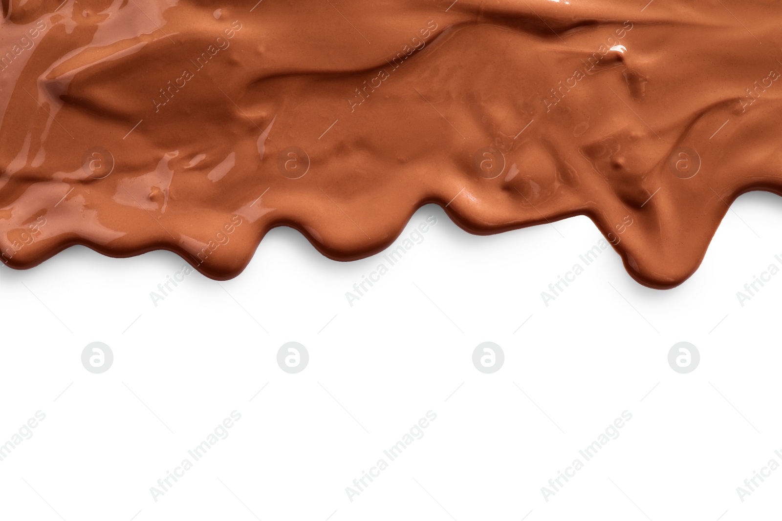 Photo of Tasty melted milk chocolate pouring down on white background