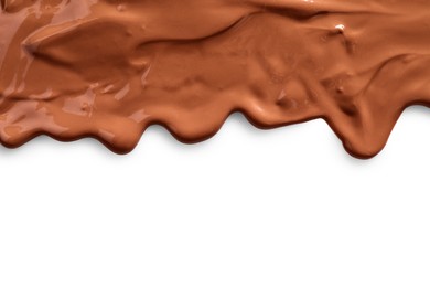 Tasty melted milk chocolate pouring down on white background