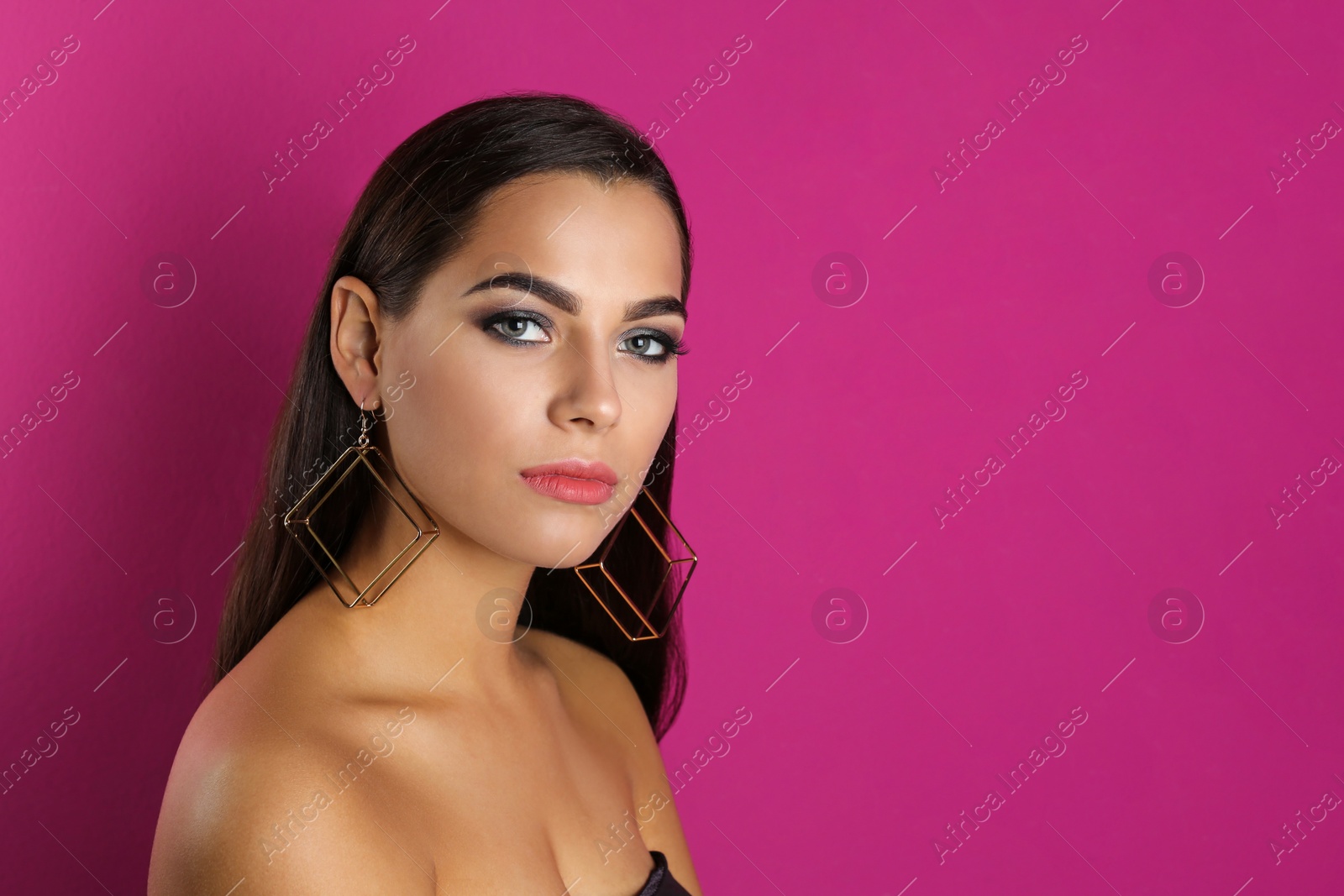 Photo of Portrait of beautiful woman with stylish makeup on color background. Space for text