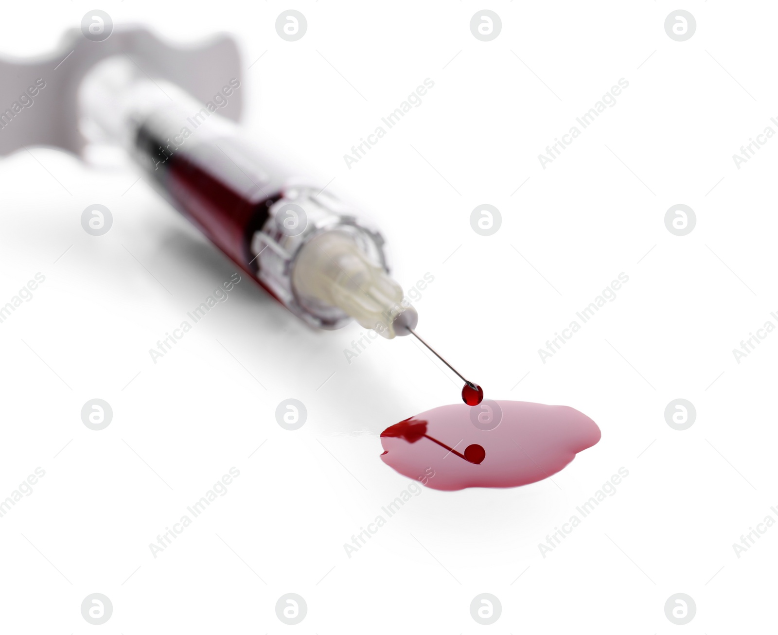 Photo of Plastic syringe with blood on white background