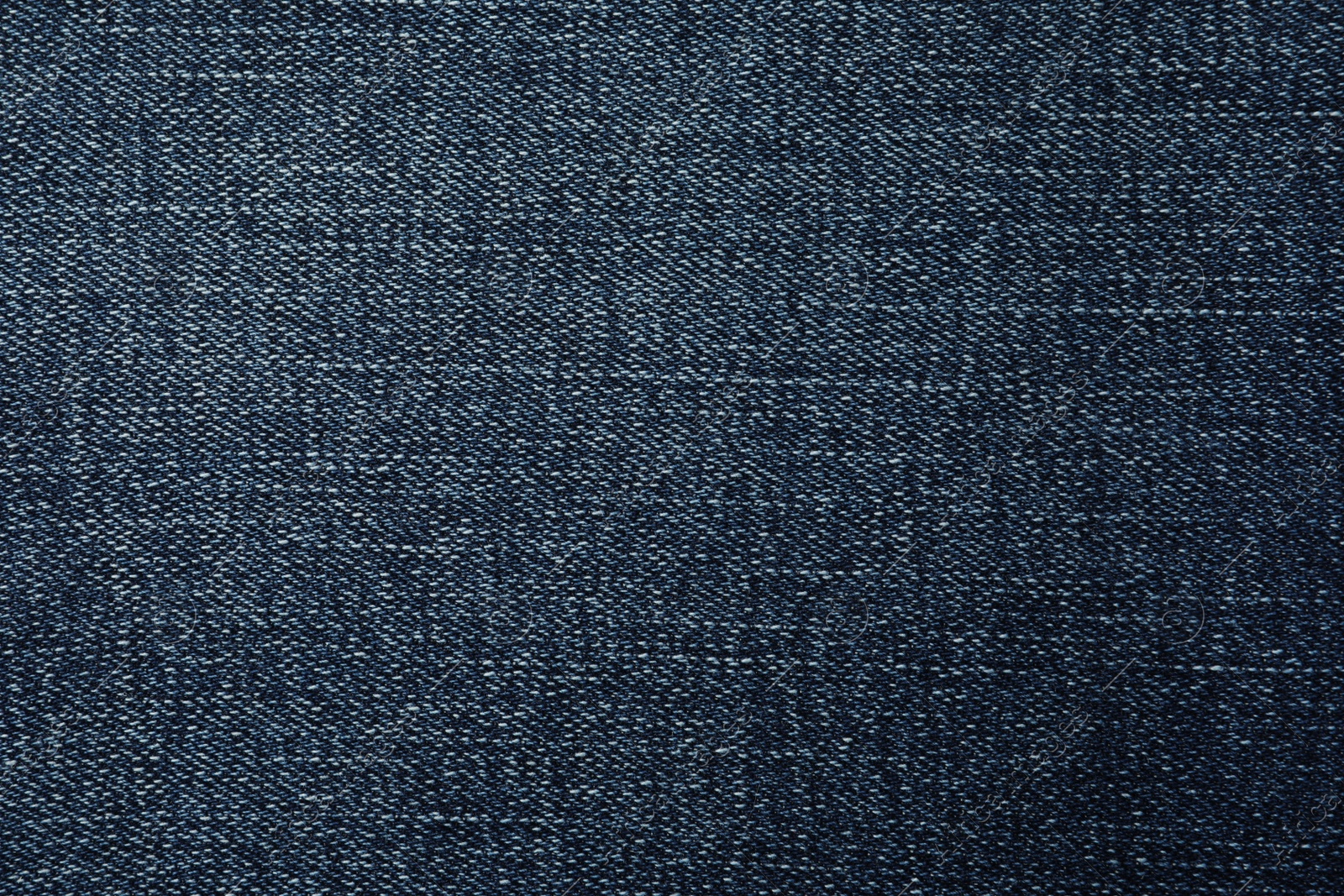 Photo of Texture of dark blue jeans as background, closeup