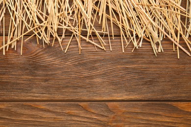 Dried hay on wooden background, flat lay. Space for text