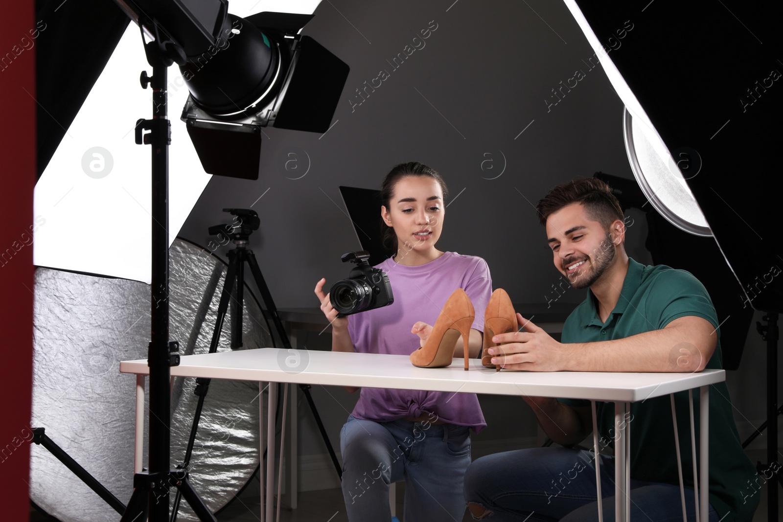 Photo of Professional photographers shooting stylish shoes in studio