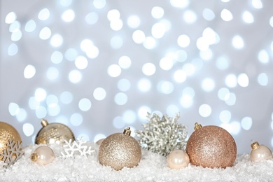 Photo of Christmas decoration on snow against blurred background