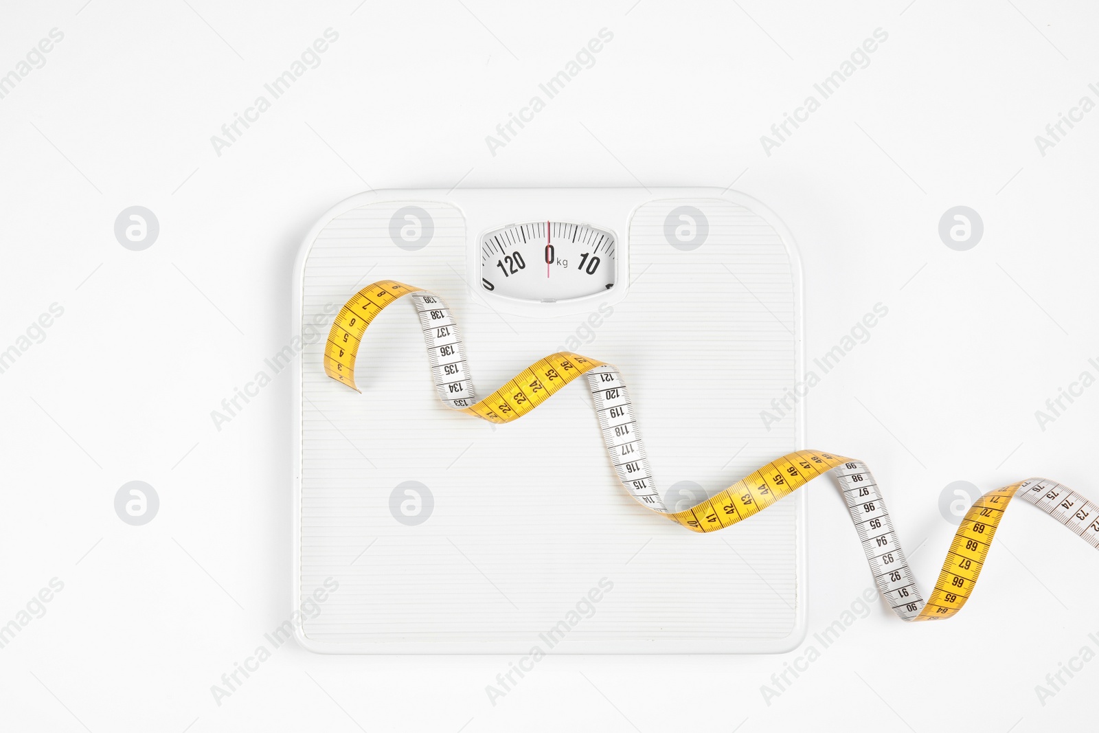 Photo of Modern scales and tape measure isolated on white, top view