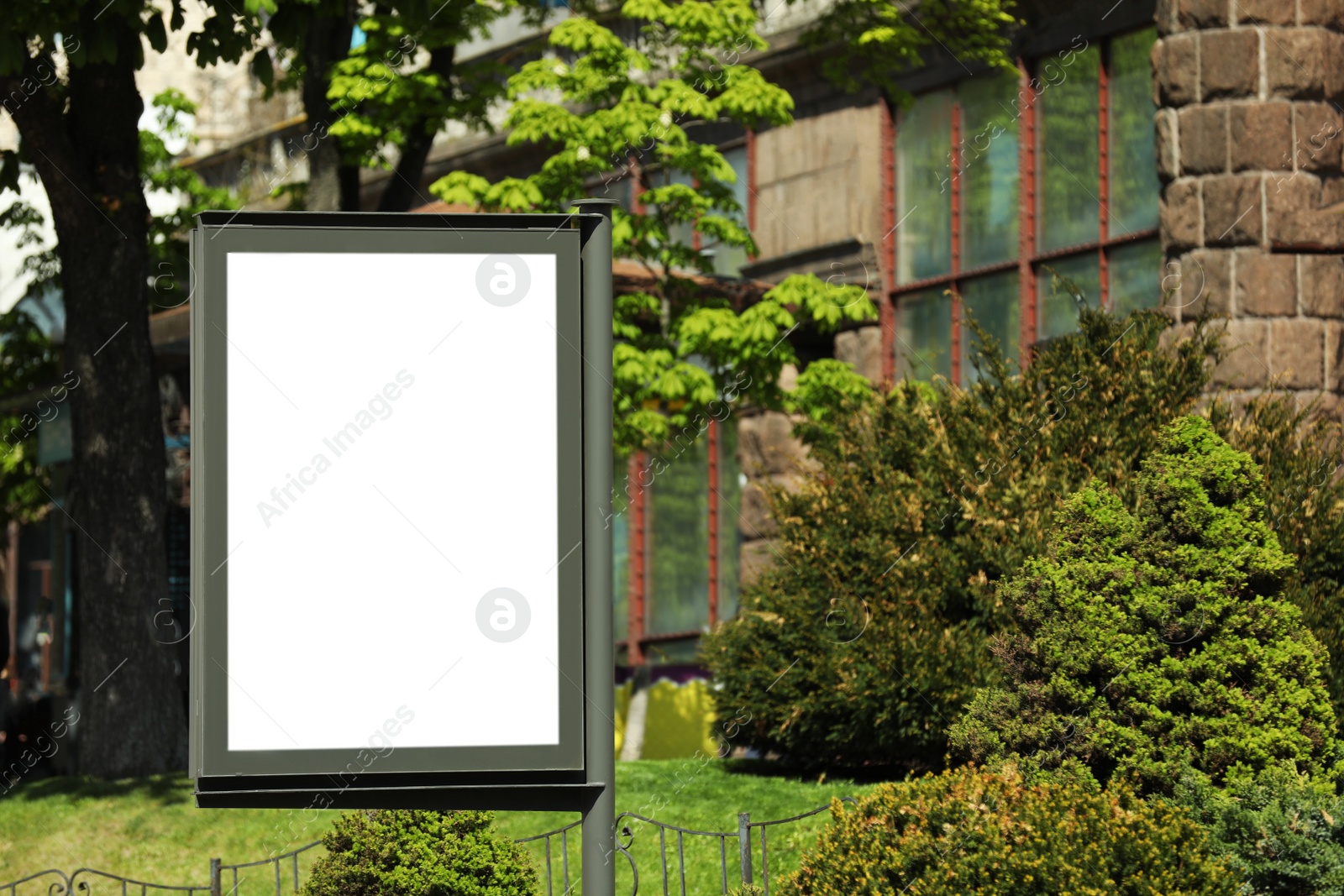 Photo of Blank advertising board on city street. Mockup for design