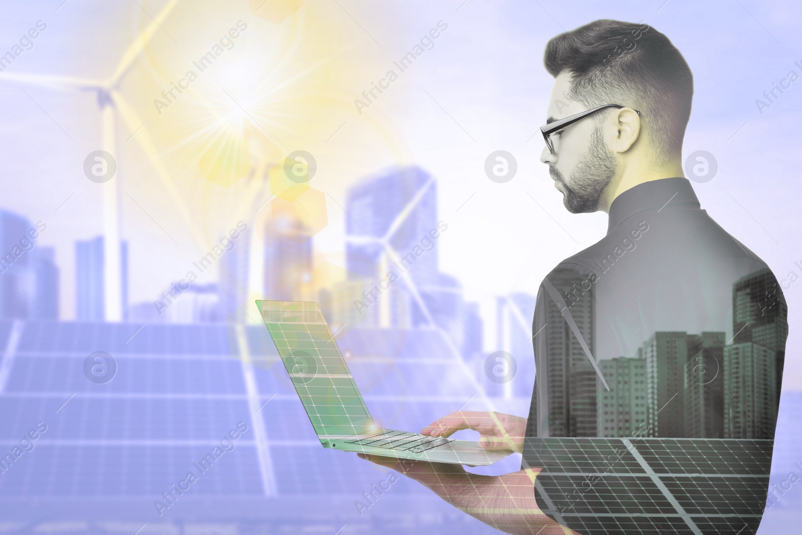 Image of Multiple exposure of businessman with laptop, wind turbines and solar panels installed outdoors. Alternative energy source