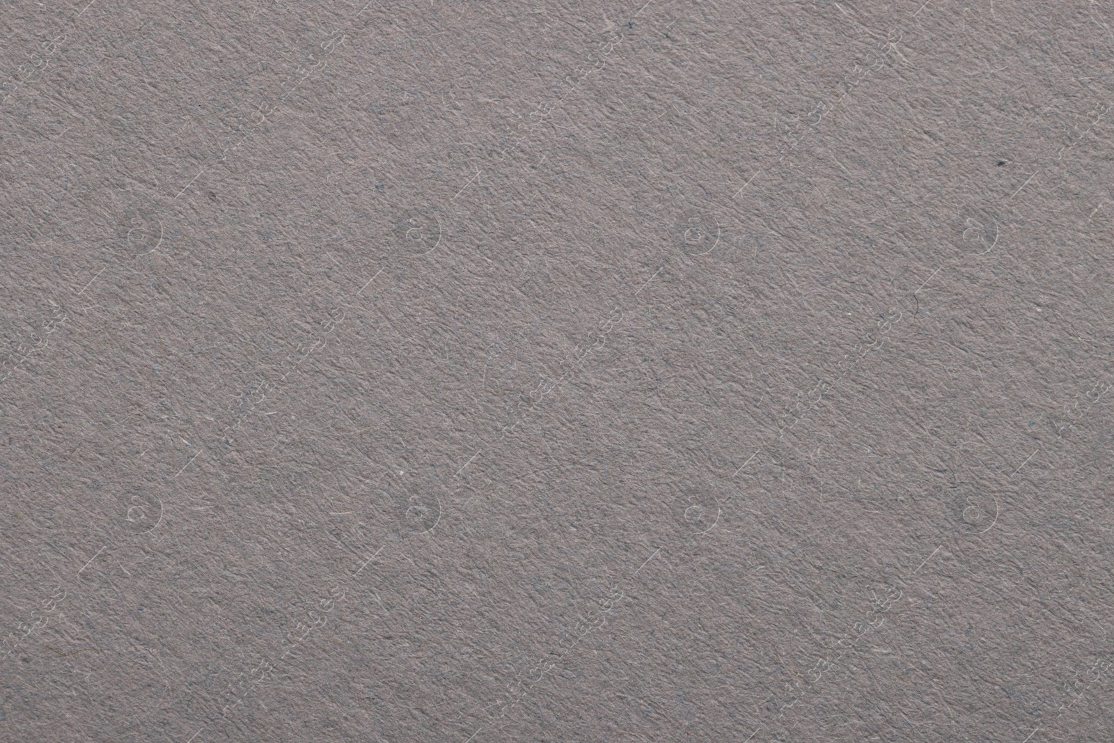 Photo of Texture of light grey paper sheet as background, top view