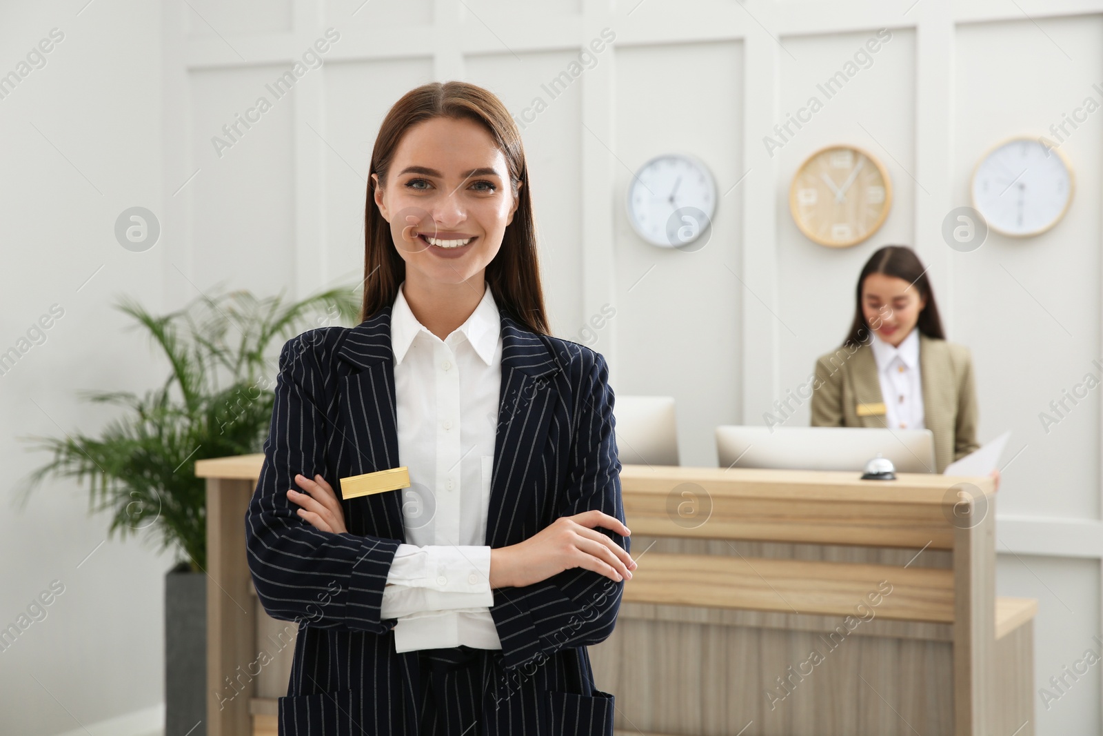 Photo of Portrait of beautiful receptionist near counter in hotel