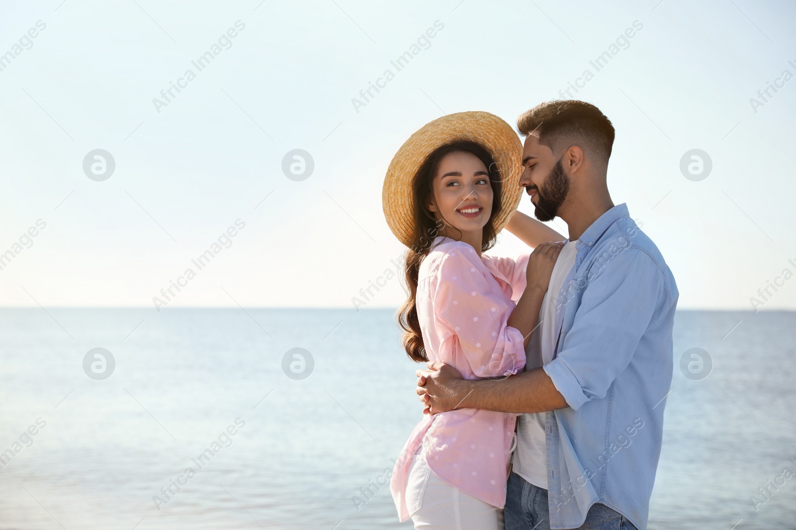 Photo of Happy young couple at beach. Honeymoon trip