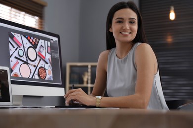 Professional retoucher working on computer in office