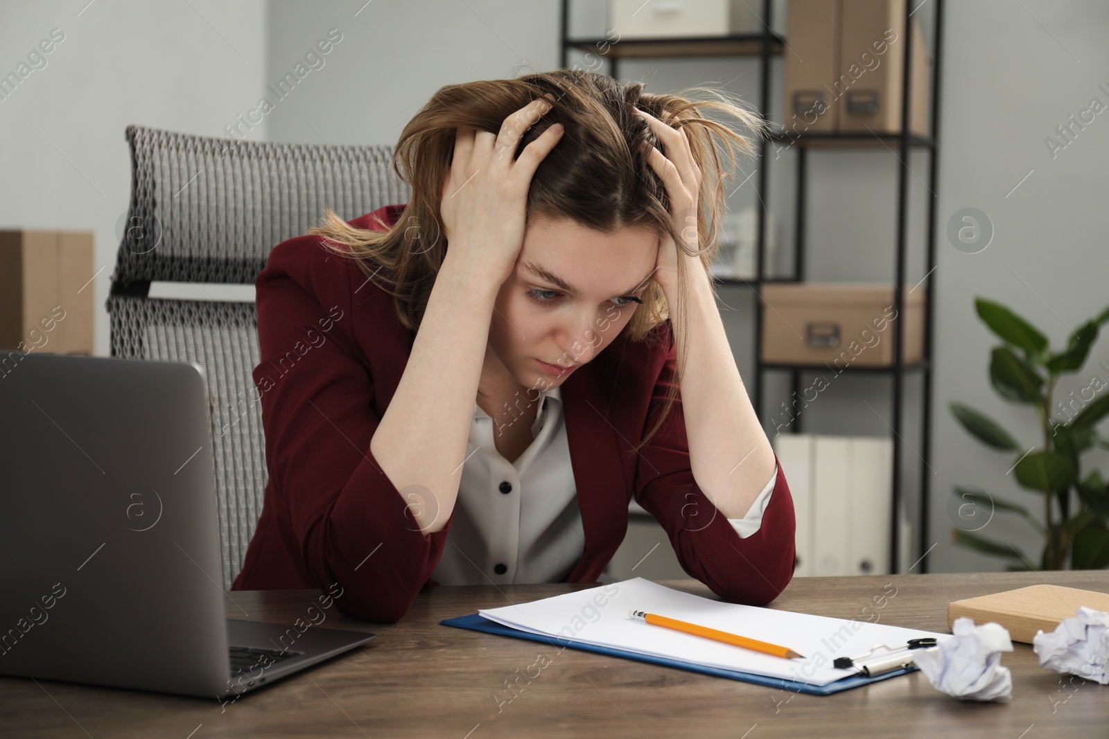 Photo of Sad businesswoman working at wooden table in office