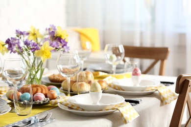 Photo of Festive Easter table setting with traditional meal at home, space for text