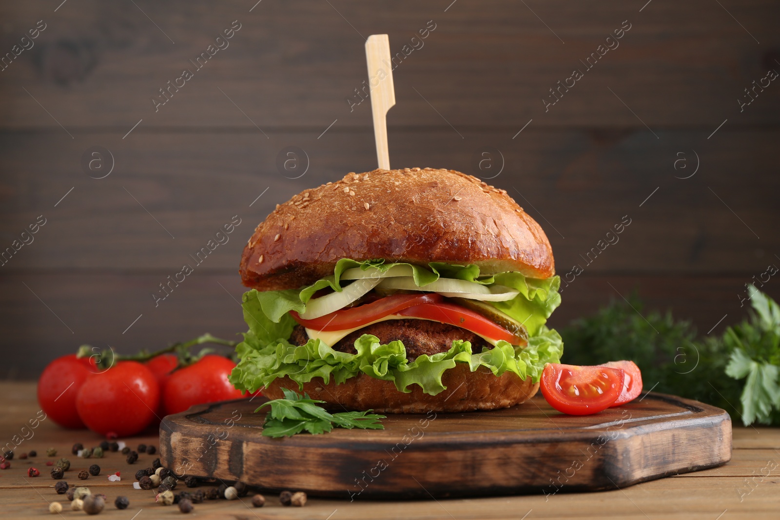 Photo of Delicious vegetarian burger served on wooden table