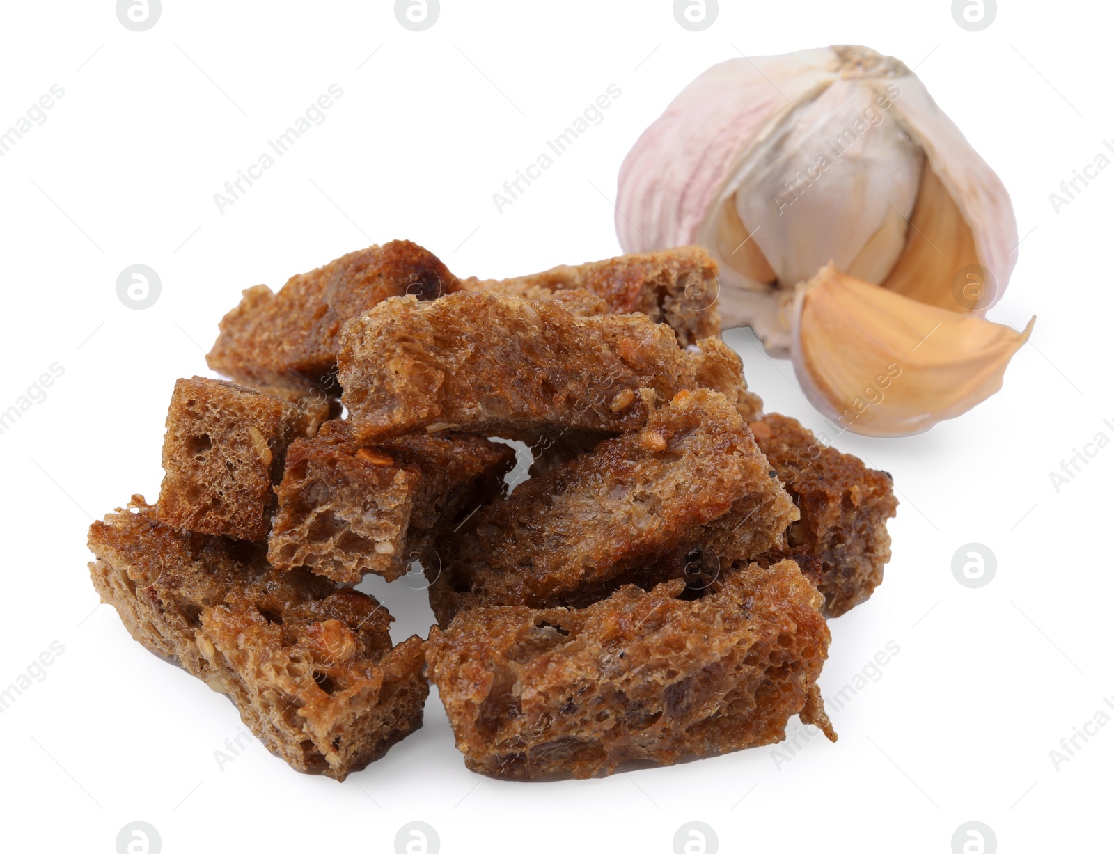 Photo of Delicious crispy rusks and garlic on white background