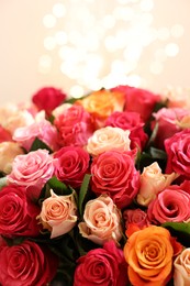 Beautiful bouquet of colorful roses on beige background