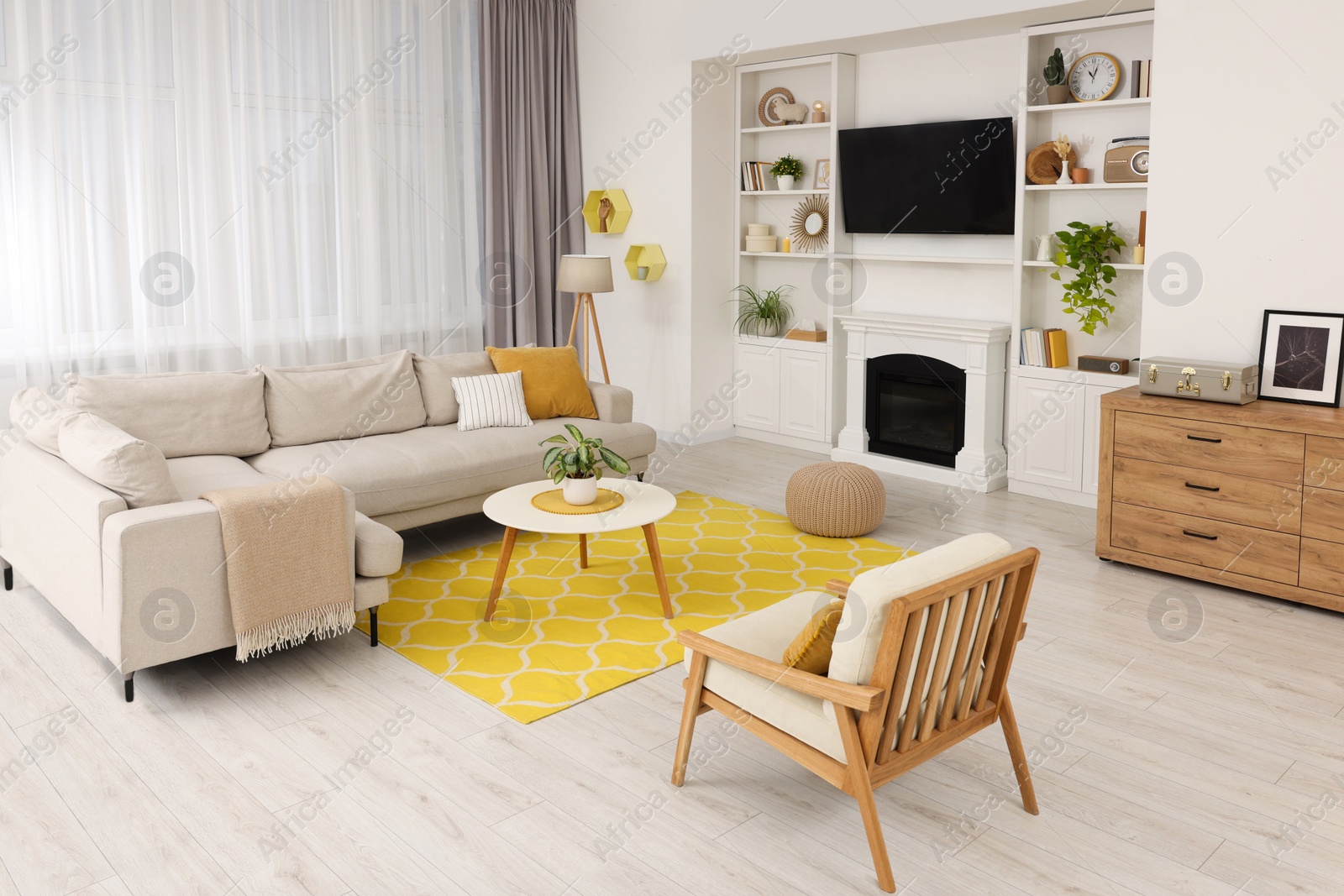 Photo of Spring atmosphere. Stylish room interior with cozy furniture in yellow and white colors