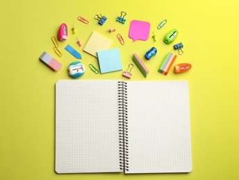 Photo of Blank notebook and school stationery on yellow background, flat lay with space for text. Back to school