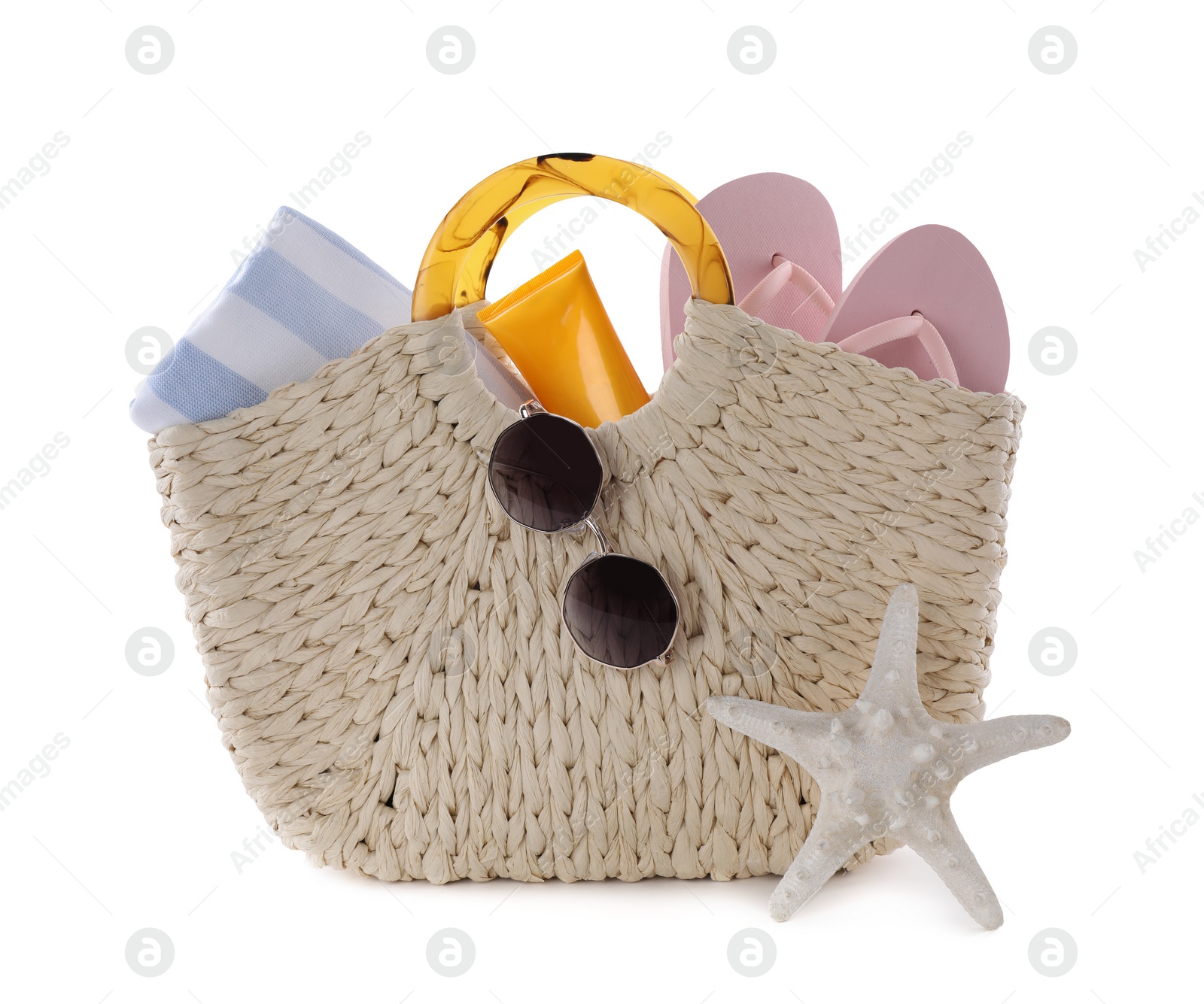 Photo of Bag with different beach objects and starfish on white background