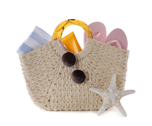 Bag with different beach objects and starfish on white background