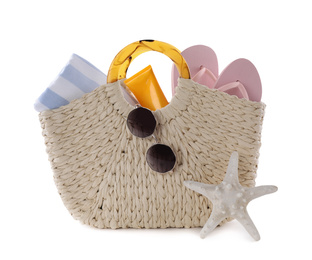 Photo of Bag with different beach objects and starfish on white background