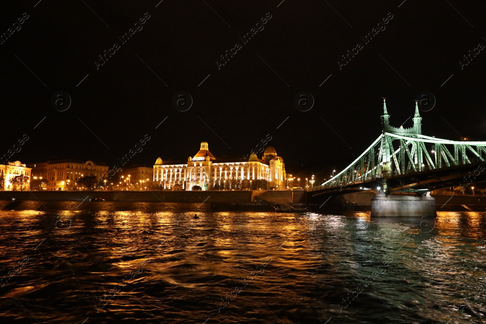 Photo of BUDAPEST, HUNGARY - APRIL 27, 2019: Beautiful night cityscape with illuminated Gellert Hotel and Liberty Bridge across Danube river