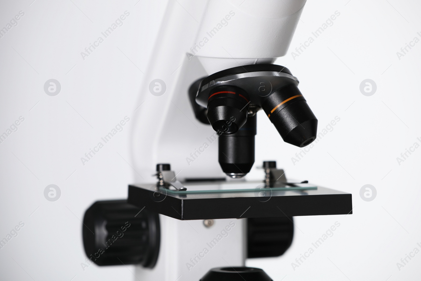 Photo of Modern microscope on light background, closeup. Medical equipment